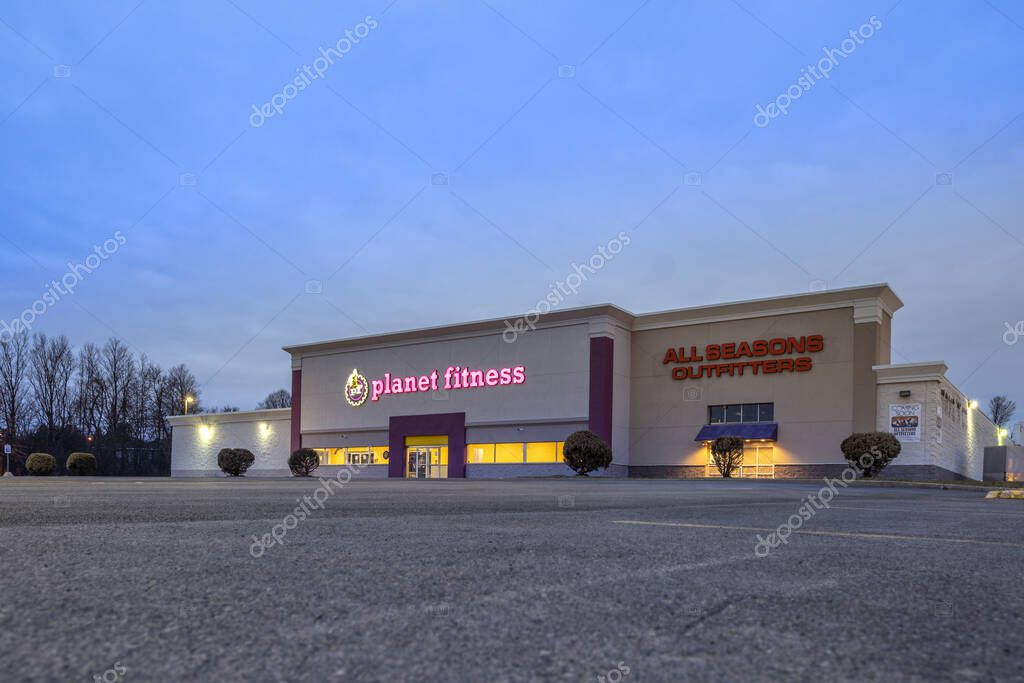 New Hartford, New York - Mar 19, 2020: Night View of Planet Fitness Gym and Workout Center, Planet Fitness Identifies Itself as a Judgment Free Zone.