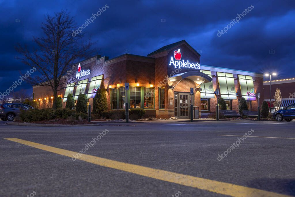 New Hartford, New York - Mar 20, 2020: Night View of Applebee's Restaurant Facade, Applebee's is an American Company, Developing franchises, and Operates the Applebee's Neighborhood Grill-Bar Restaurant Chain.