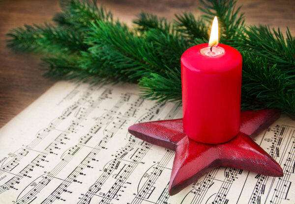 Christmas Music Sheet Music with Burning Candle