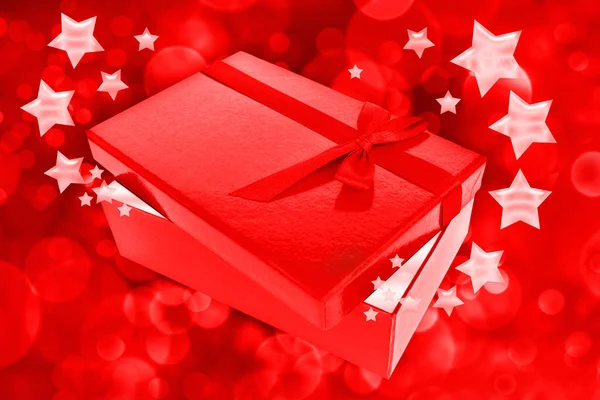 Rotes Geschenk mit Sternen und Bokeh — Stockfoto