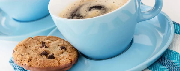 Blue cup with coffee and biscuits