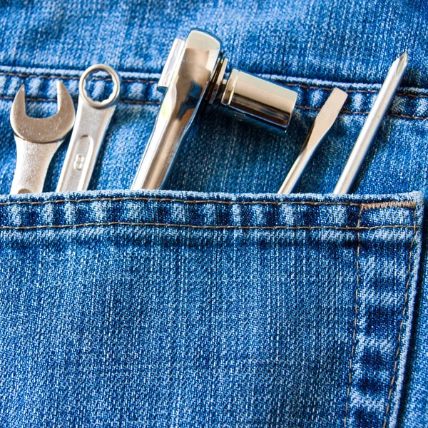 Jeans pocket with tools as background — Stock Photo, Image
