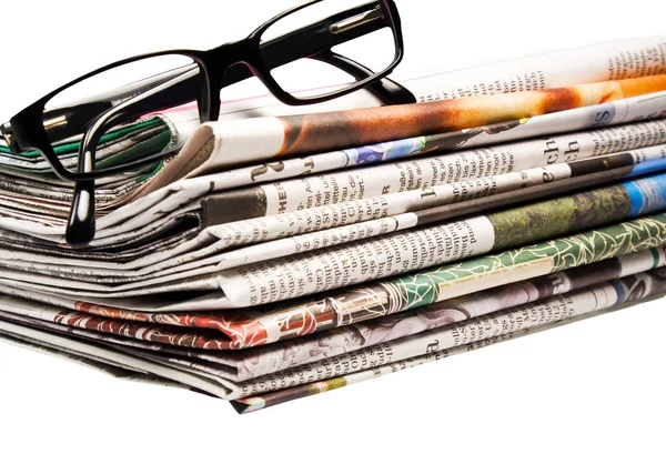 Newspapers with glasses News as background — Stock Photo, Image