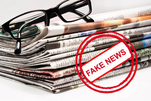 Daily newspaper and glasses fake news as background