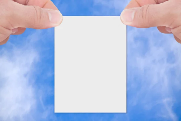 Paper with hands on sky background