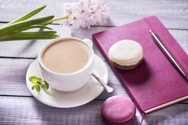 Pink macaroon with pink  hyacinth on the wooden background
