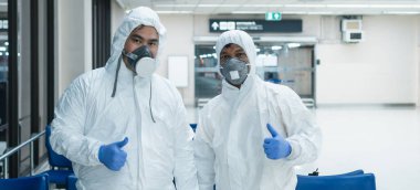 Tehlikeli bölge. Virüs hızla yayılıyor. İki Asyalı tıbbi personel koruyucu giysiler giyer ve maske takar. Şu anda virüsü yaymak için bölgede çalışıyor.