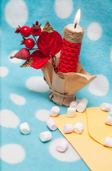 On a blue background red candle marshmallow on the envelope — Stock Photo, Image