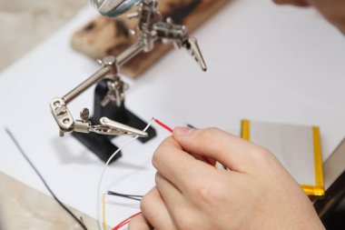 erkek sanatçı lehim teli atölye ile çalışır