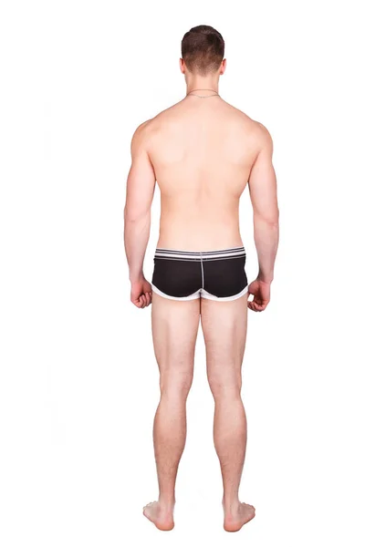 Man in underwear standing on a white background, and turned his back to the camera — Stock Photo, Image