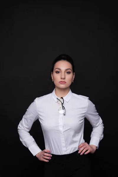 Young successful business woman. Girl on a black background in a white blouse — Stock Photo, Image