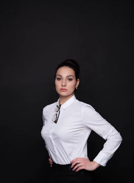 Young successful business woman. Girl on a black background in a white blouse — Stock Photo, Image