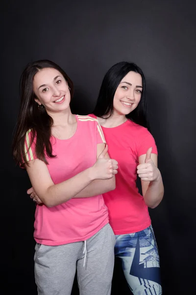 Two sports Cheerful young woman showing a thumbs up — Stock Photo, Image