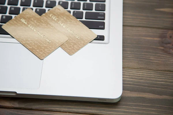 Two gold credit cards on laptop keyboard — Stock Photo, Image