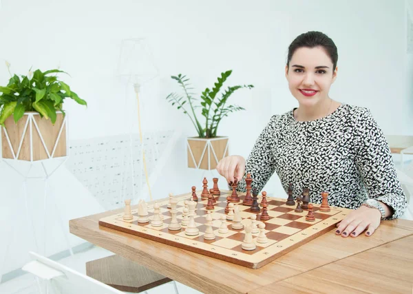 Young woman and chess board with chess