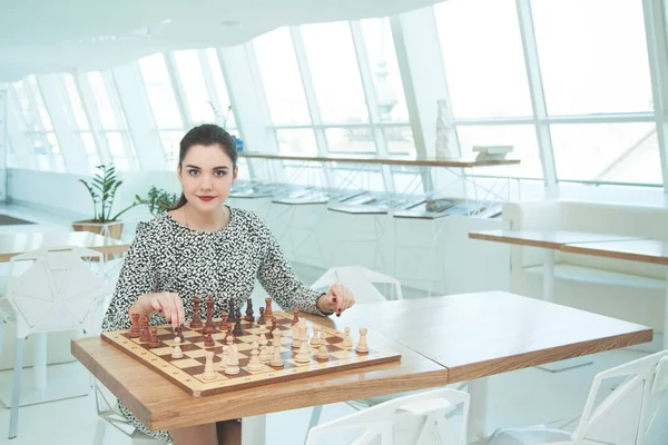 Business woman playing chess