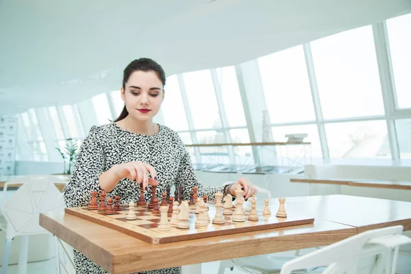 Business woman playing chess
