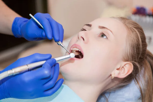 Woman at the dentist\'s chair during a dental procedure.