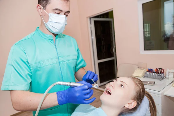 Woman at the dentist\'s chair during a dental procedure.