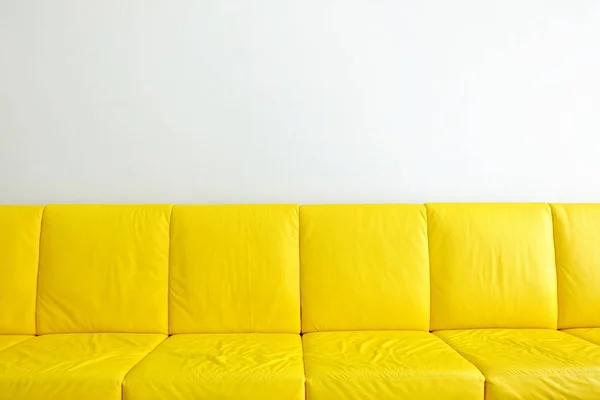 Yellow Sofas with White Wall Background.