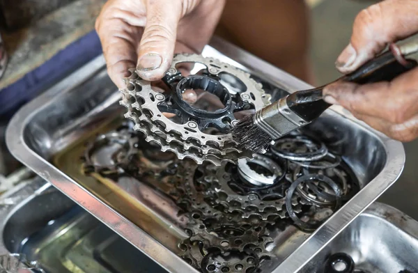 Monteur schoonmaken een fiets cassette — Stockfoto