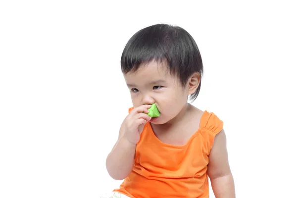 Young baby trying to put a small piece of toy — Stock Photo, Image