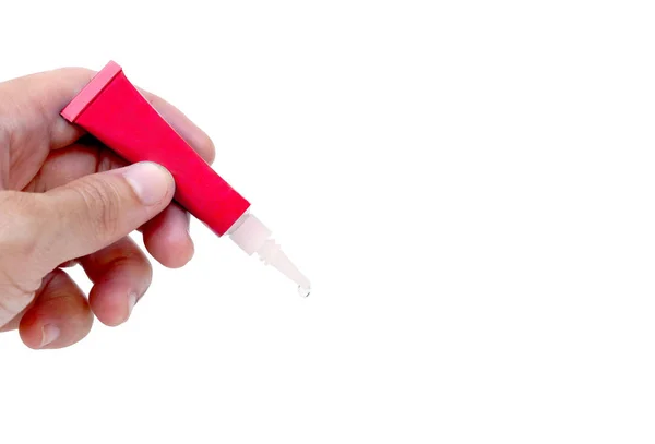 Hand holding a superglue tube — Stock Photo, Image