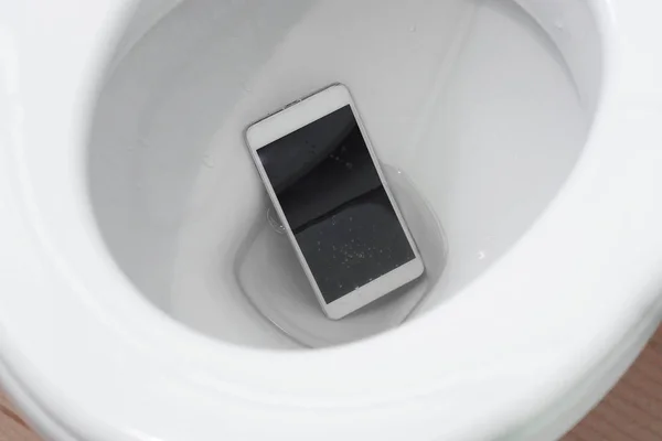Smartphone dropped into a toilet — Stock Photo, Image