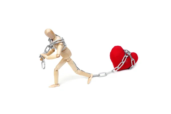 Mannequin pulling big red heart — Stock Photo, Image