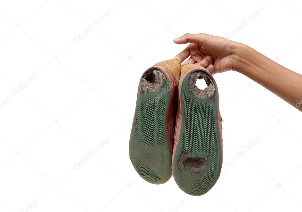 Student holding worn out shoes