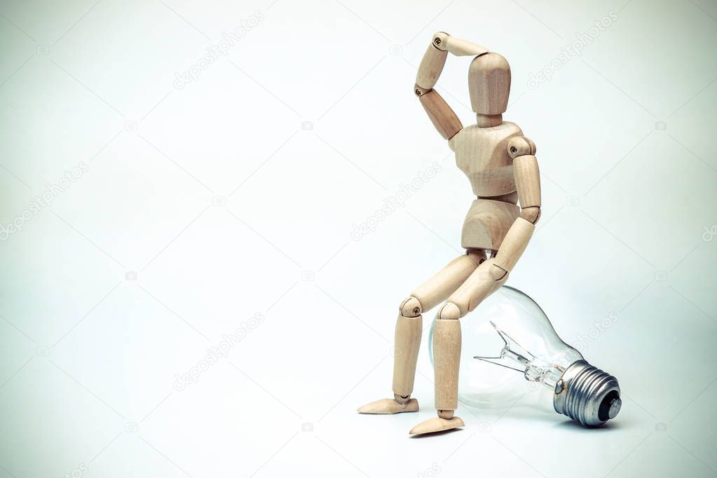 Mannequin sitting on light bulb