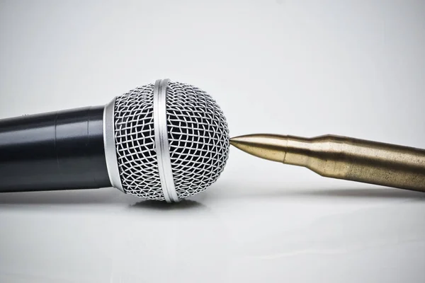 Microphone vs. Bullets / Freedom of the press is at risk concept / World press freedom day concept