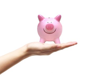 Pembe bir kumbara tutan el 