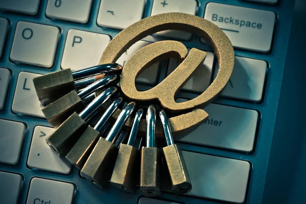 Email sign with many padlocks on computer keyboard — Stock Photo, Image