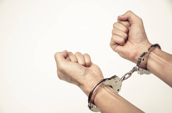 Silver handcuffs on male hands 