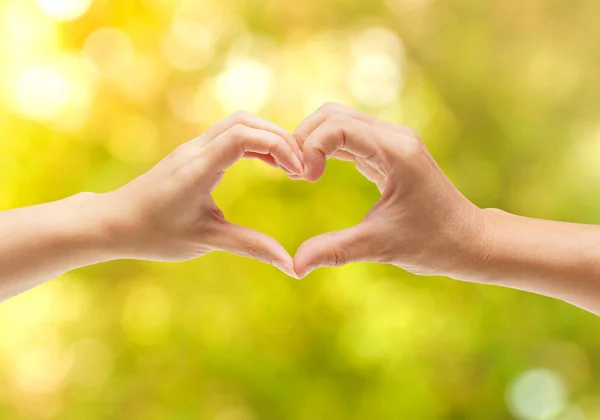 Hands of a couple forming a heart shape — Stock Photo, Image