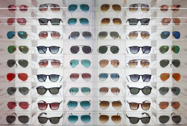 Eyeglasses and sunglasses on shelves clipart