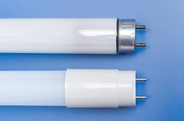 Led light tube vs fluorescent light tube on blue background