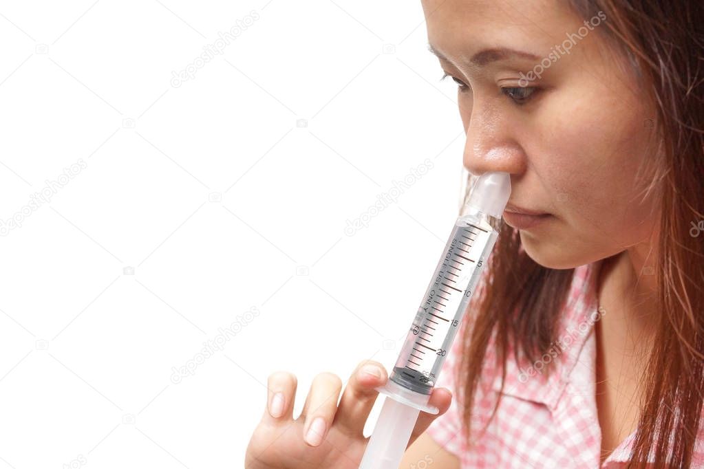 Asian female doing nasal irrigation isolated with copy space to add text