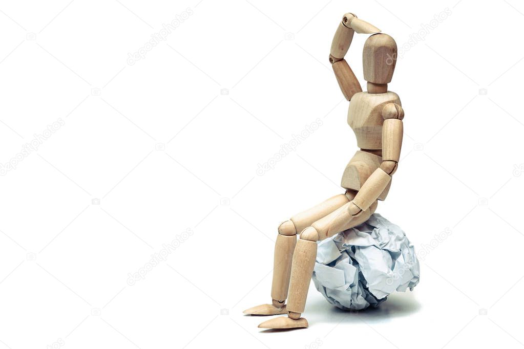 Wood figure mannequins sitting on a crumpled paper ball / Having no bright ideas