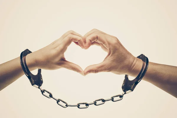 一对夫妇的手用手铐 爱和情人节概念形成一个心形 — 图库照片