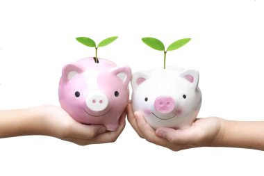 Two kids holding piggy banks with green trees isolated on white background - Green business starting from young generation concept clipart