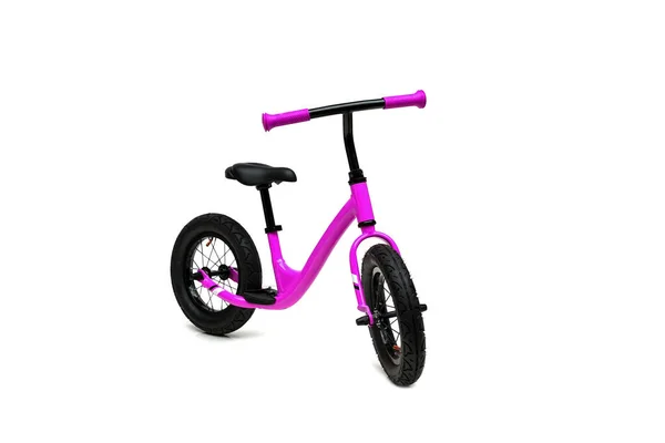 A pink balance bike isolated on white background