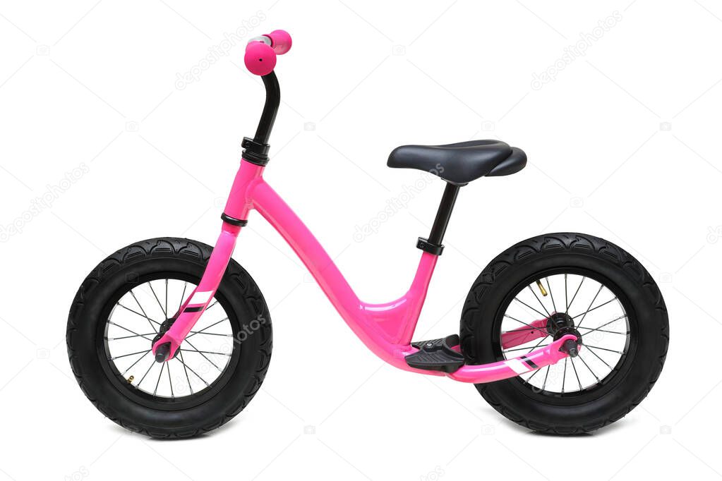A pink balance bike isolated on white background