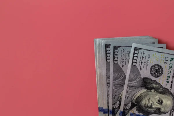Flat closeup of dollars on pink background. Investment profit income. Success concept. Finance investment concept. Flat design element. Dollar sign. Hundred dollar bill.