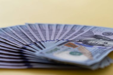 Sarı arka planda hayran dolarları var. Yatırım kar geliri. Başarı konsepti. Finans yatırım konsepti. Düz tasarım elemanı. Dolar işareti. Yüz dolarlık banknot..