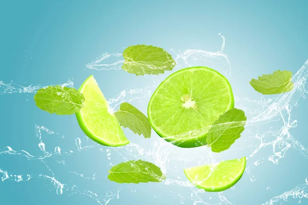 Lime and mint, water splash isolated on blue background — Stock Photo, Image
