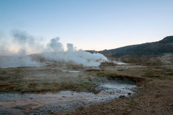Geothermal area in Icelandic nature. Smoke and sulfur smell.