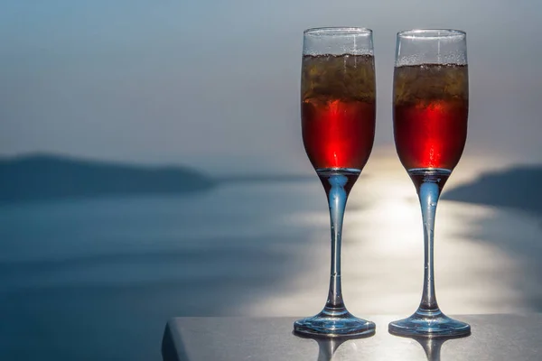Romantic red sunset drinks with ocean view. Romantic, valentines, drinks and restaurant, party, concepts.