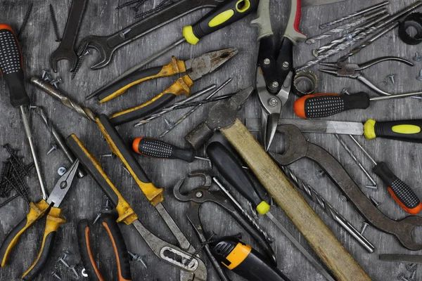 Gri arka planda dekorasyon ve yenileme için gerekli aletler tamir ediliyor. Üst görünüm